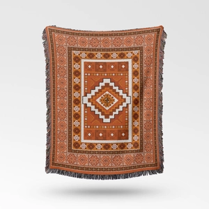 Close-up of bohemian woven blanket featuring geometric patterns and fringe tassels