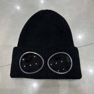 Detailed close-up of the knitted texture and integrated goggles on this black beanie
