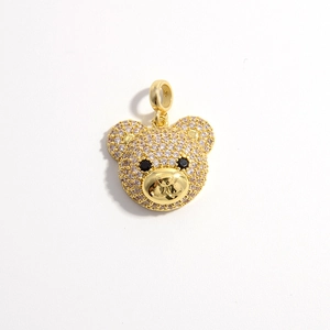 Close-up of a gold-plated bear pendant encrusted with sparkling white cubic zirconia