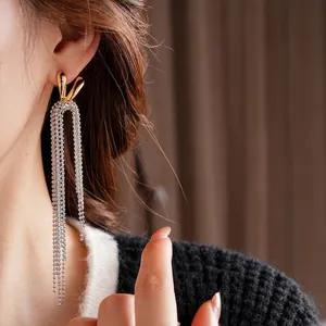 Elegant 18k gold plated long metal tassel earrings with silver bead chains on model