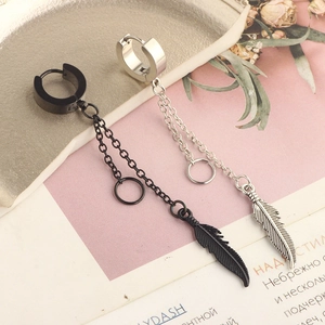 Detail of long chain earrings with feather pendants in black and silver finishes