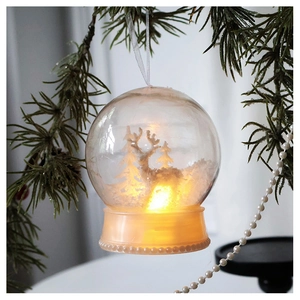Close-up of LED Christmas ball featuring a white reindeer, pine tree and warm light