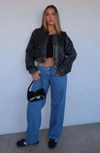 Classic straight-leg blue jeans paired with a black cropped bomber jacket and handbag