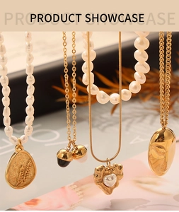 Detailed view of four assorted gold-plated necklaces with pearls and vintage pendants
