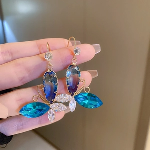 Elegant gold butterfly earrings with blue-purple gradient crystals and clear zircon accents