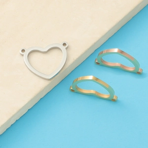 Titanium steel hollow heart-shaped double-hole connectors in gold, silver, and rose gold