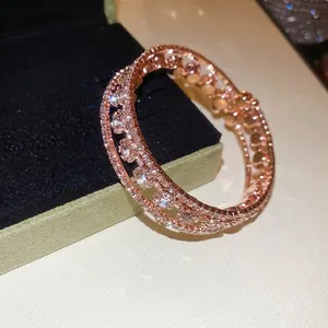 Elegant rose gold three-layer open bangle with sparkling cubic zirconia in micro-pave setting