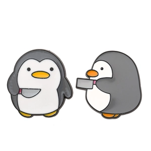 Set of two cute cartoon penguin enamel pins with knife accessory for bags and clothes