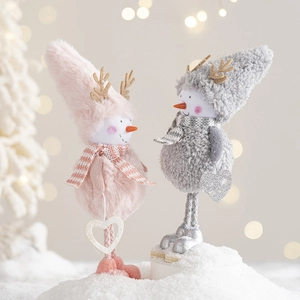 Cute pink and grey Christmas snowman plush figurines with glitter hearts on snow
