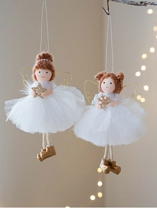 Close-up of angel girl ornaments with white mesh dress and gold sequins on branches