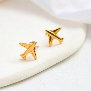 Macro shot of gold-plated airplane stud earrings made of high-quality titanium steel