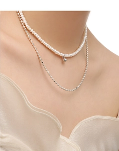 Close-up of double-layer necklace featuring white freshwater pearls and silver beads