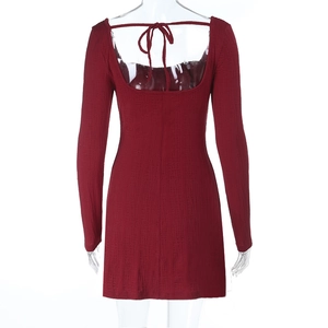Detail of red backless dress showing knitted rib texture and lace-up back design