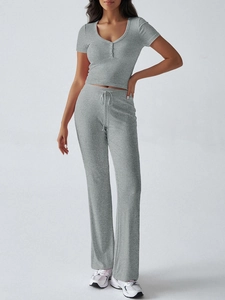 Dettaglio completo set grigio in maglia con t-shirt scollo a U e pantaloni larghi con coulisse