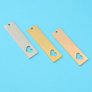 Three mirror-polished stainless steel bar pendants with heart cutouts in gold and silver