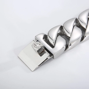 Macro detail of high-polish stainless steel Cuban chain dog collar with secure buckle