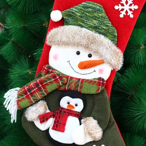 Christmas stockings with 3D snowman and penguin hanging on a festive Xmas tree