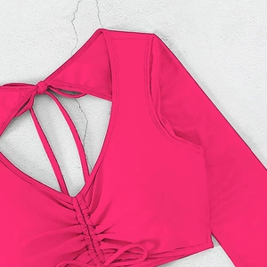 Detail view of pink long sleeve bikini top with drawstring ruched front and V-neckline