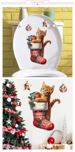 Detail of Christmas cat sticker showing a ginger cat in a red sock on a toilet lid