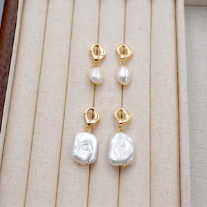 French vintage baroque pearl earrings with square gold hardware on beige velvet display