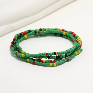 Detailed close-up of double-layer colorful seed beads on a white fabric background