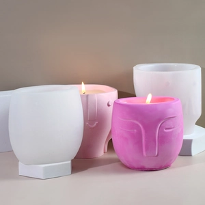 Detail of matte facial relief candle cups in white, pink and rose tones for aromatherapy