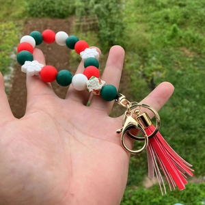Detail of Christmas silicone bead wristlet keychain with snowman motif and red tassel