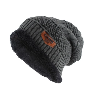 Close-up of thick thermal fleece lining and knitted texture on a dark grey winter beanie