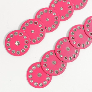 Detail of rose pink leather belt discs with silver metal eyelets and punk style rivets