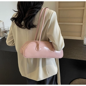 Pink leather shoulder bag shown from behind on model for a trendy minimal aesthetic