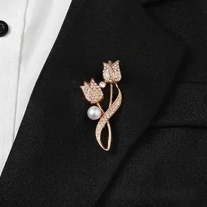 Close-up of elegant tulip brooch with white crystals and pearl on black suit lapel