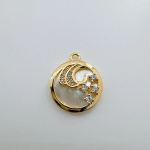 Detailed macro of 18K gold-plated round sun and moon shell pendant with zircon