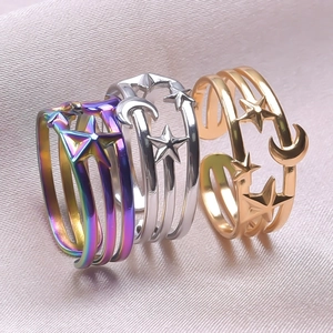 Three open rings with hollow star and moon designs in rainbow, silver and gold finishes