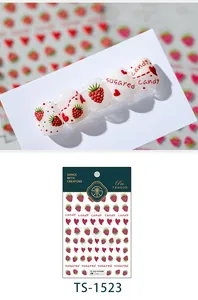 Detailed macro view of 3D embossed raspberry nail stickers with red hearts and script design