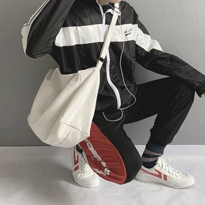 Minimalist white large canvas crossbody bag shown on model for daily commuting