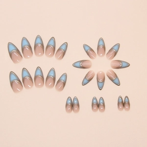 French almond fake nails with nude pink base, blue tips and gold border detailing