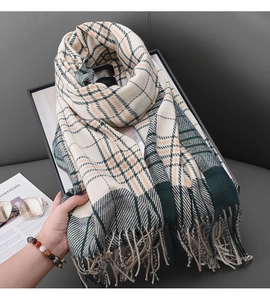 Close-up of soft plaid scarf with fringe detail, beige with green and orange accents