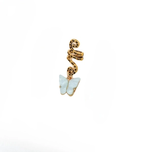 Detail of golden snake hair ring with a translucent light blue resin butterfly pendant