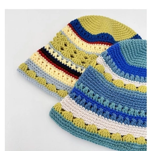 Close-up of wavy knit texture on vintage-style floral pattern bucket hats in vibrant colors