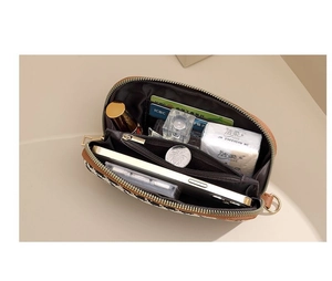 Interior detail of houndstooth clutch showing multiple compartments and card slots