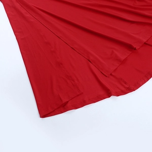 Detail of red sexy backless dress showing side slit and high-quality hemline stitching