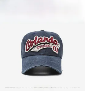 Close-up of vintage washed navy baseball cap with Orlando 01 3D embroidery and worn brim