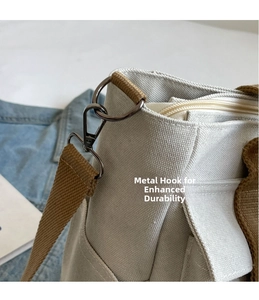 Macro detail of high-quality metal hooks and zipper closure on beige canvas bag