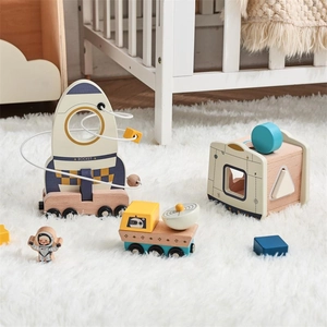 Close-up of wooden space toy set including rocket bead maze and lunar rover on plush rug