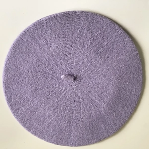 Top view of a soft light purple knitted beret with center stem detail for women