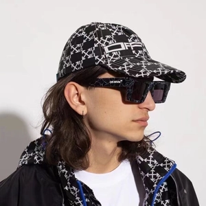 Modern black square sunglasses and baseball cap with arrow patterns on model