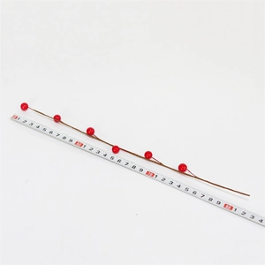 Detailed view of artificial red berry branch with measurement tape showing 80cm length