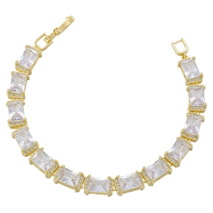 Macro view of gold chain bracelet with emerald-cut cubic zirconia and pavé stones