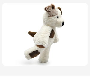 Detailed side view of a soft plush puppy toy with brown spots and creamy white fur
