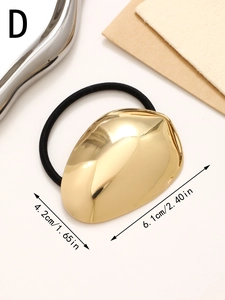 Close-up of geometric gold metal hair tie showing 4.2cm x 6.1cm dimensions and mirror finish